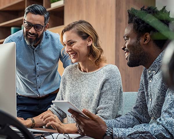 People working around a computer using and LMS